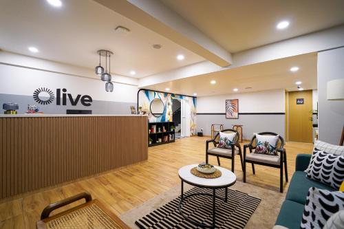 a lobby of a store with chairs and a table at Olive Hotel Baner by Embassy Group in Pune