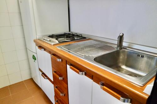 a small kitchen with a sink and a stove at Dany's house in Lecco