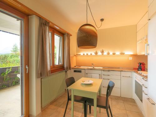 a kitchen with a table and chairs and a window at Apartment Chesa Tscheppa 1 by Interhome in Sils Maria