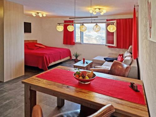 a living room with a bed and a table with a bowl of fruit at Apartment Studio Flumserberg by Interhome in Flumserberg
