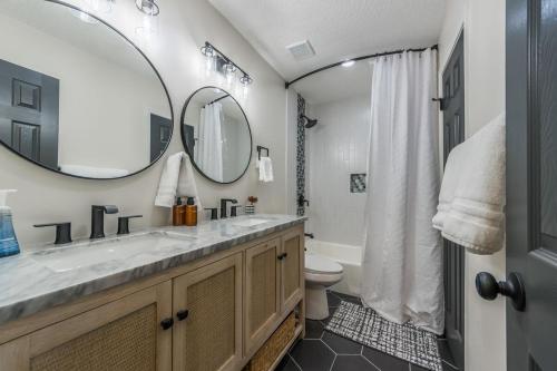 a bathroom with a sink and a toilet and a mirror at 4BR World Cup Fan HQ SuperHost Close to Stadium in Pleasant Valley