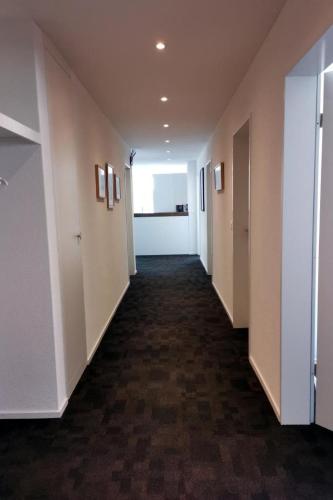 a hallway of an office building with white walls at Apartment HIRSCHEN by Interhome in Gossau