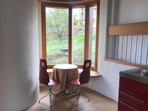 a kitchen with a table and two chairs and a window at Apartment sunehus-ch by Interhome in Stein