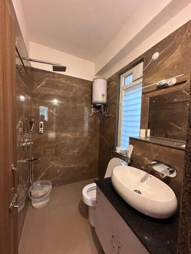 a bathroom with a sink and a toilet at Royale Serenity in Gangtok