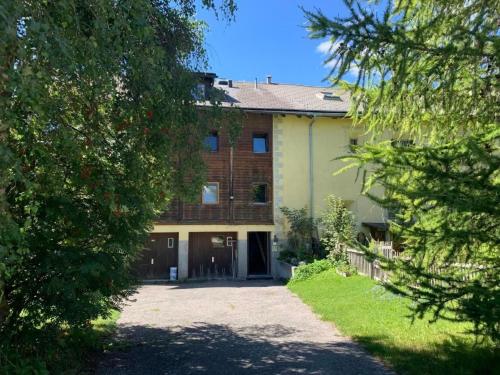 a large brick building with a driveway in front of it at Apartment Wohnung Grün by Interhome in La Punt-Chamues-ch