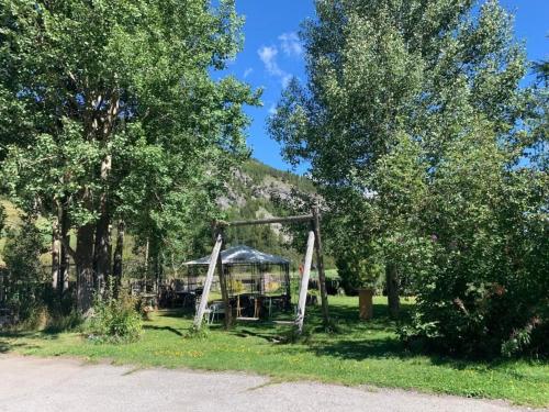a playground in a park with a gazebo at Apartment Wohnung Grün by Interhome in La Punt-Chamues-ch