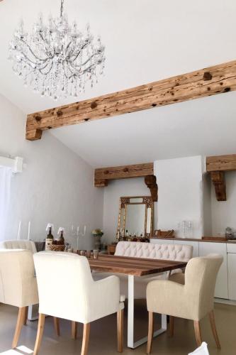 a dining room with a table and white chairs at Apartment Alpenchic SpycherHus by Interhome in Klosters