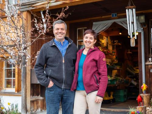 a man and a woman standing in front of a house at Apartment Hof Bommes by Interhome in Gais