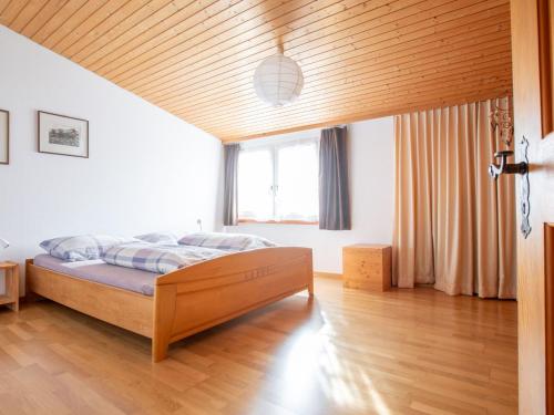 a bedroom with a bed and a wooden ceiling at Apartment Hof Bommes by Interhome in Gais