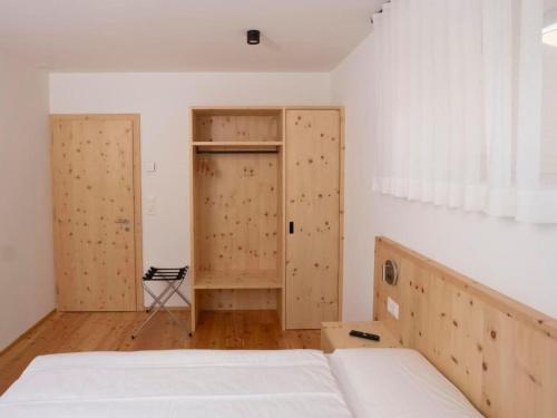 a bedroom with two closets and a bed in it at Apartment Duai by Interhome in Müstair