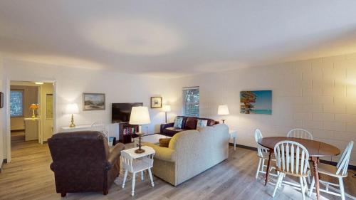 a living room with a couch and a table at Atlantic Breeze #4 in Jekyll Island