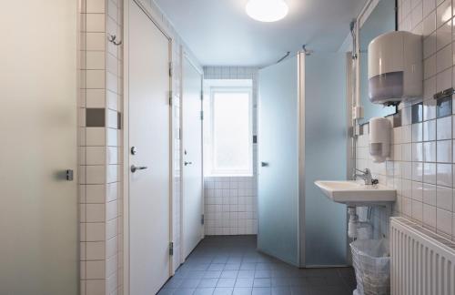 a bathroom with a sink and a shower at Partille Vandrarhem in Partille