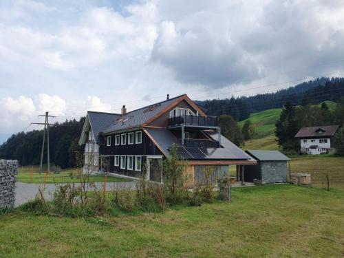 a large house in a field with a house at Apartment Bädli by Interhome in Wildhaus