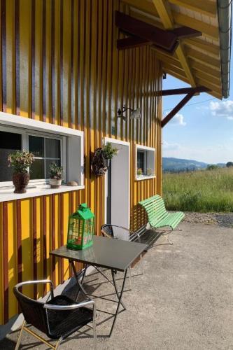 two chairs and a table outside of a building at Apartment nirkwerk by Interhome in Schönengrund