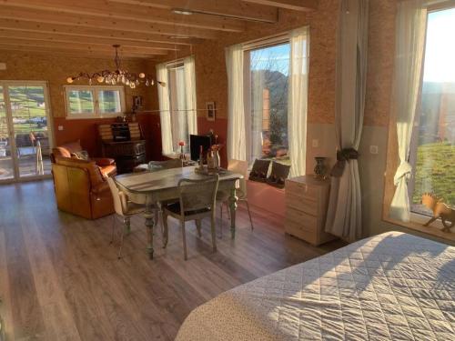 a bedroom with a dining room table and a kitchen at Apartment nirkwerk by Interhome in Schönengrund