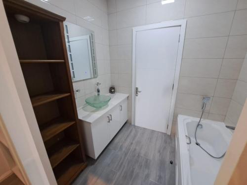 a bathroom with a sink and a toilet and a mirror at The Heritage Roches Noires in Roches Noires