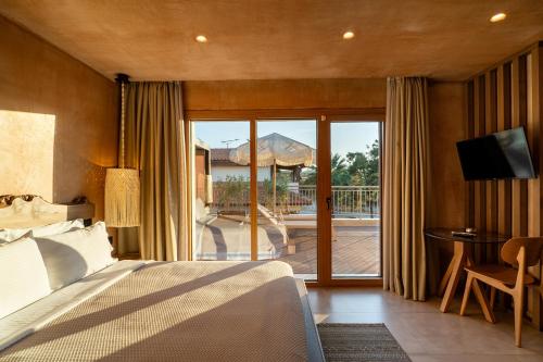 a bedroom with a bed and a sliding glass door at Salud Ierissos in Ierissos
