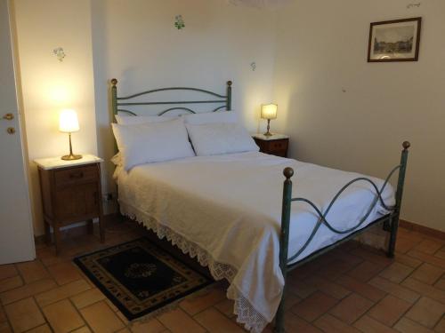 a bedroom with a bed with two night stands and two lamps at Bellevue, country house in Velletri