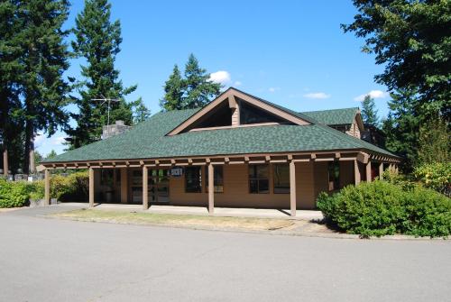 a building with a green roof on a street at Tall Chief Camping Resort Yurt 5 in Pleasant Hill
