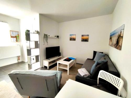 a living room with a couch and a tv at Apartment Studio-Wohnung Heide2 mit Terrasse by Interhome in Walsrode
