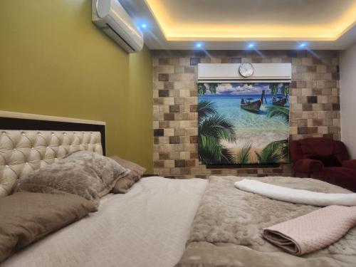a bedroom with a bed and a painting on the wall at A big Family nice sunset flat in Amman