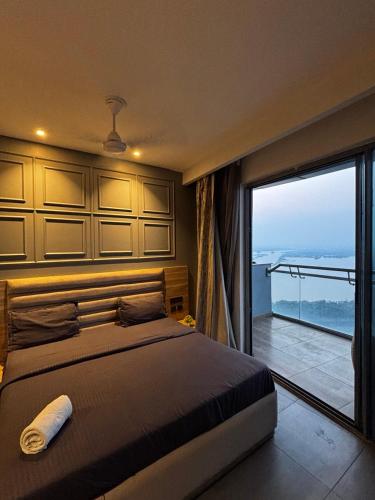 a bedroom with a bed and a large window at Supernova spira in Noida