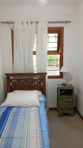 a bedroom with a bed and a window at Casa con pileta, Mar Azul in Mar Azul