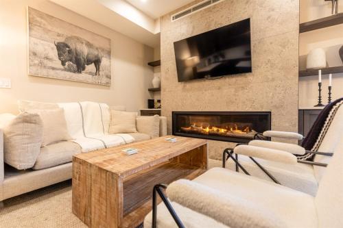 a living room with a couch and a fireplace at Polar Peak Lodges by Fernie Central Reservations in Fernie