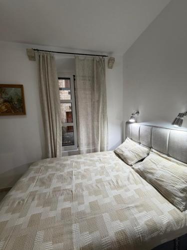 a bedroom with a large bed with a window at Old town Kotor Square in Kotor