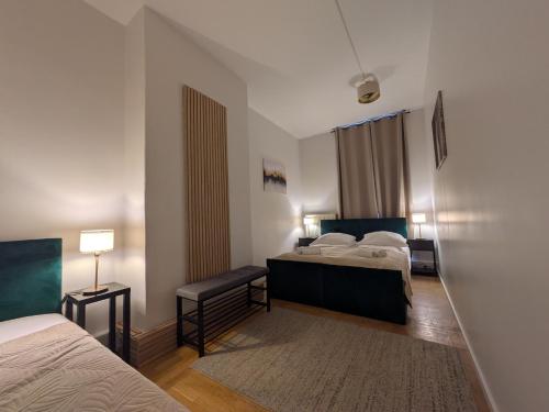 a hotel room with two beds and a rug at Munich Apartment 110 qm with 3 Bedrooms very cetral location 1 to 10 Guests in Munich
