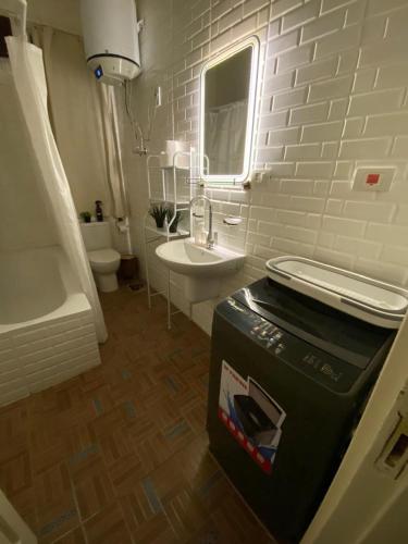 a white bathroom with a sink and a toilet at Menna's home in Cairo