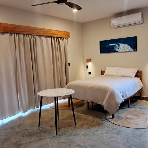 a bedroom with a bed and a table at Hotel Calma Celesti in Perihuete