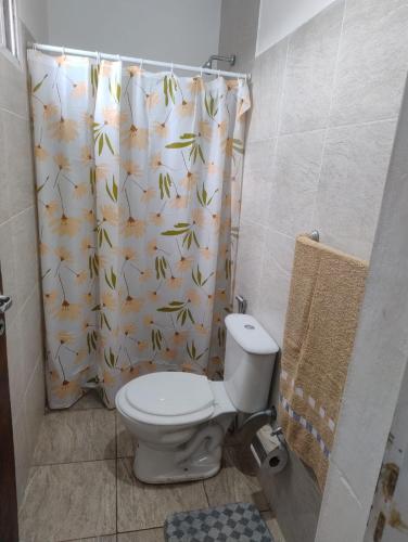 a bathroom with a toilet and a shower curtain at Rincon de Olivares in Los Olivares