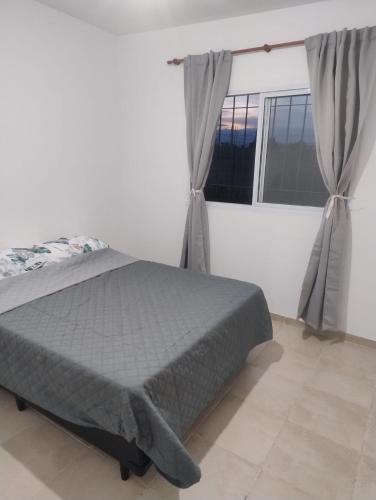 a bedroom with a bed and a window at Rincon de Olivares in Los Olivares