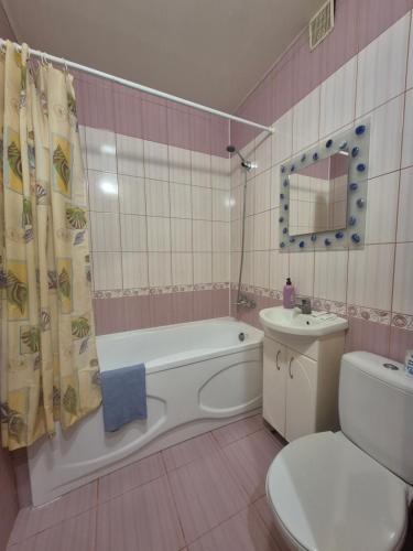 a bathroom with a tub and a toilet and a sink at Апартаменты in Izmail