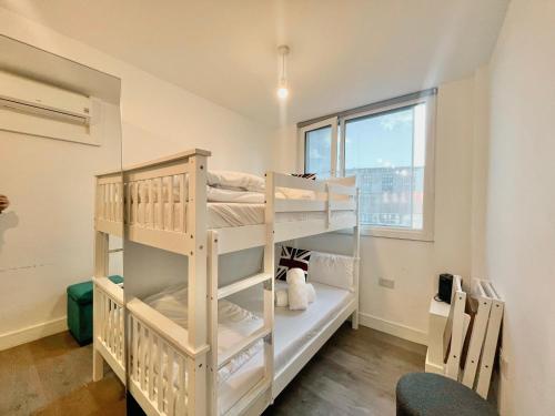 a room with two bunk beds in it with a window at Rooms in Kings Cross in London