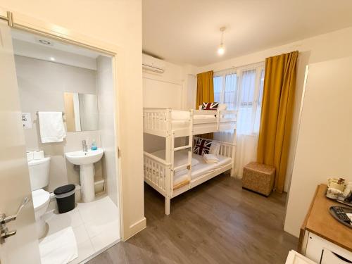 a small bathroom with a sink and a toilet at Rooms in Kings Cross in London