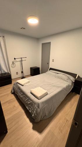 a bedroom with a bed with two towels on it at Andrei's nest in Oklahoma City