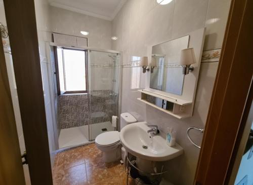 a bathroom with a sink and a toilet and a shower at El BurbyI in Somo