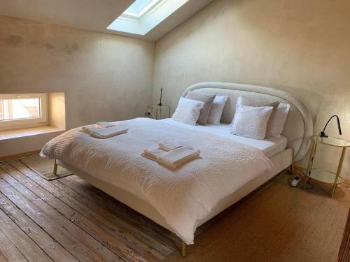a bedroom with a large bed with two towels on it at Apartment AMARCORD Loft by Interhome in Biasca
