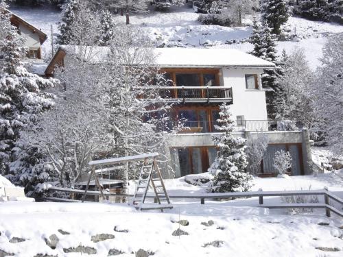 a house in the snow with at Apartment Studio by Interhome in Bever