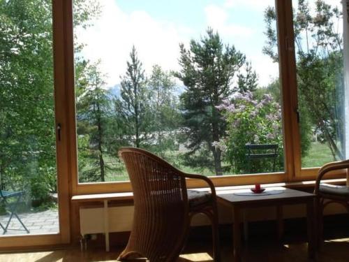 a room with a large window with chairs and a table at Apartment Studio by Interhome in Bever