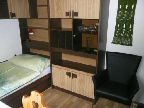 a small bedroom with a bed and a chair at Apartment Chesa Margretta by Interhome in Sils Maria