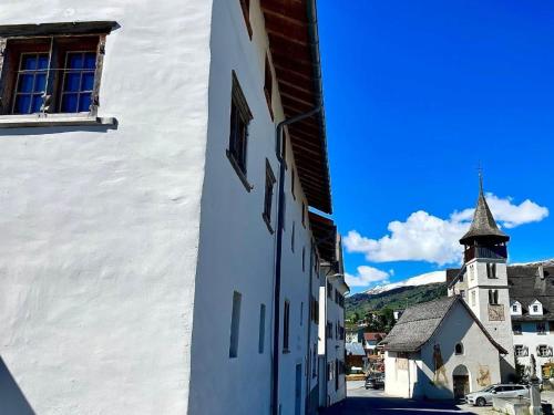 a white building with a tower and a church at Apartment casa M by Interhome in Vella