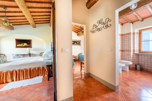 a room with a bed and a bathroom in a house at Agriturismo Panzanello in Panzano