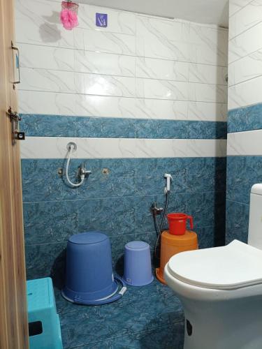 a bathroom with a toilet and three stools at Casa Iris - One Bedroom in a 3BHK Apartment in Hyderabad