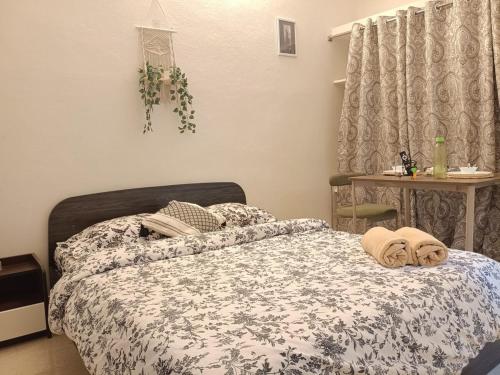a bedroom with a bed with a comforter on it at Casa Iris - One Bedroom in a 3BHK Apartment in Hyderabad