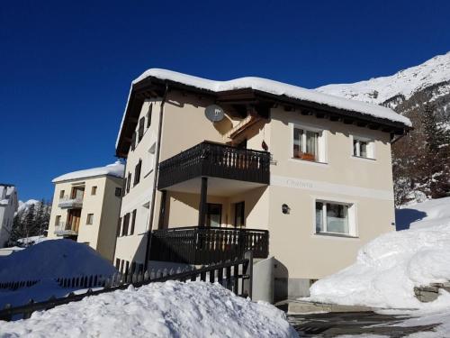 a building with a balcony in the snow at Apartment Chasura by Interhome in Pontresina