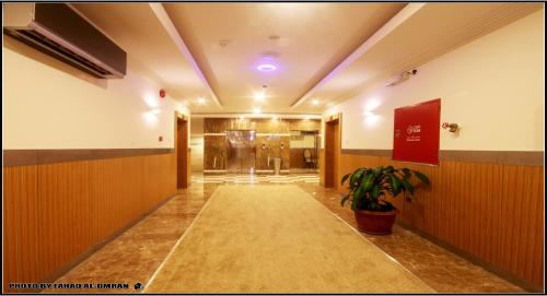 a hallway of a building with a potted plant at Taraf Yanbu 2 in Yanbu