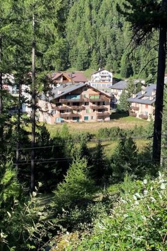 a large building in the middle of a forest at Apartment Wohnung Curtins by Interhome in Pontresina